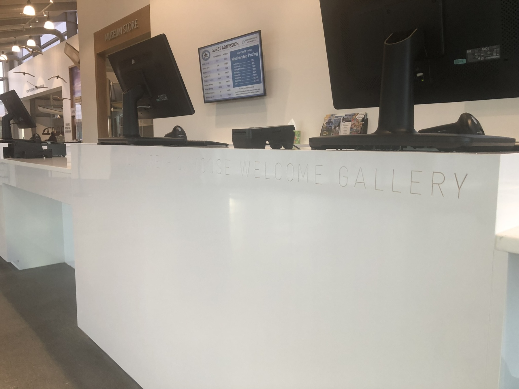 Finished reception desk with engraved Welcome Gallery lettering in solid surface