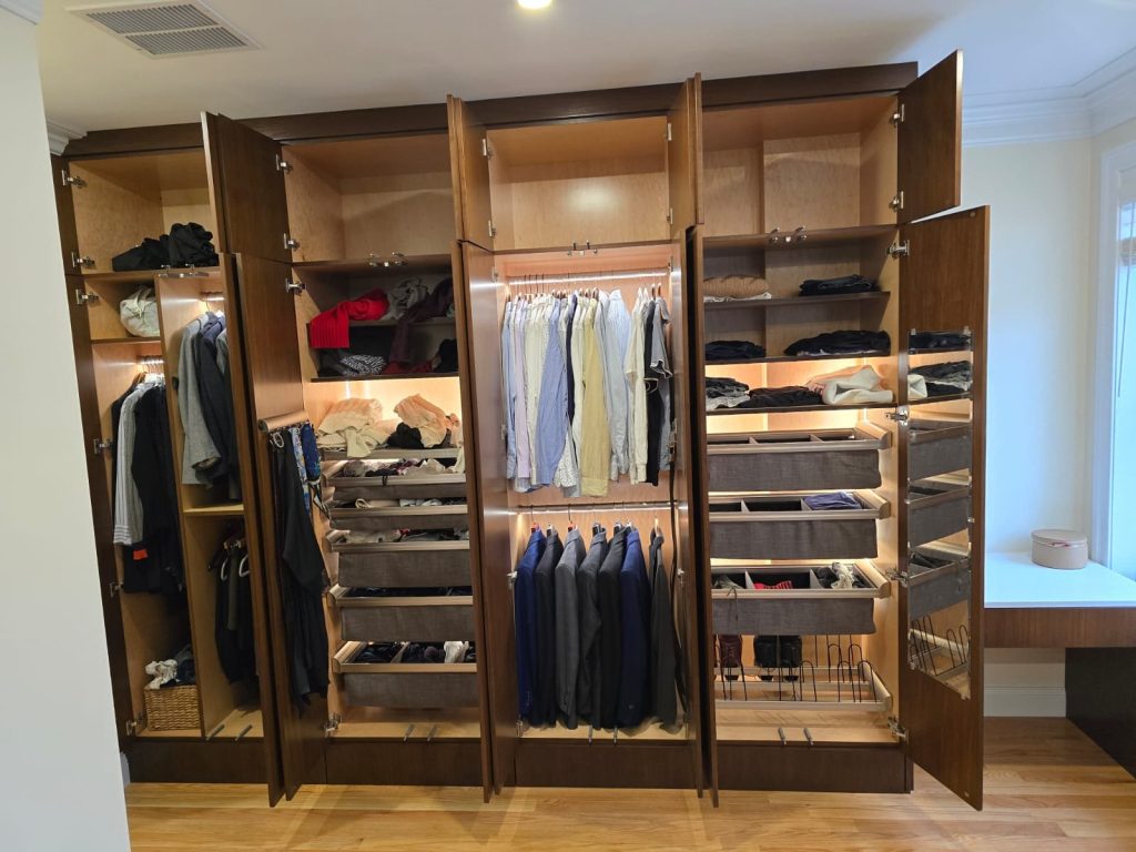 Built-in wardrobe with lighted fitted interior, pull-out racks and drawers, by SMFW