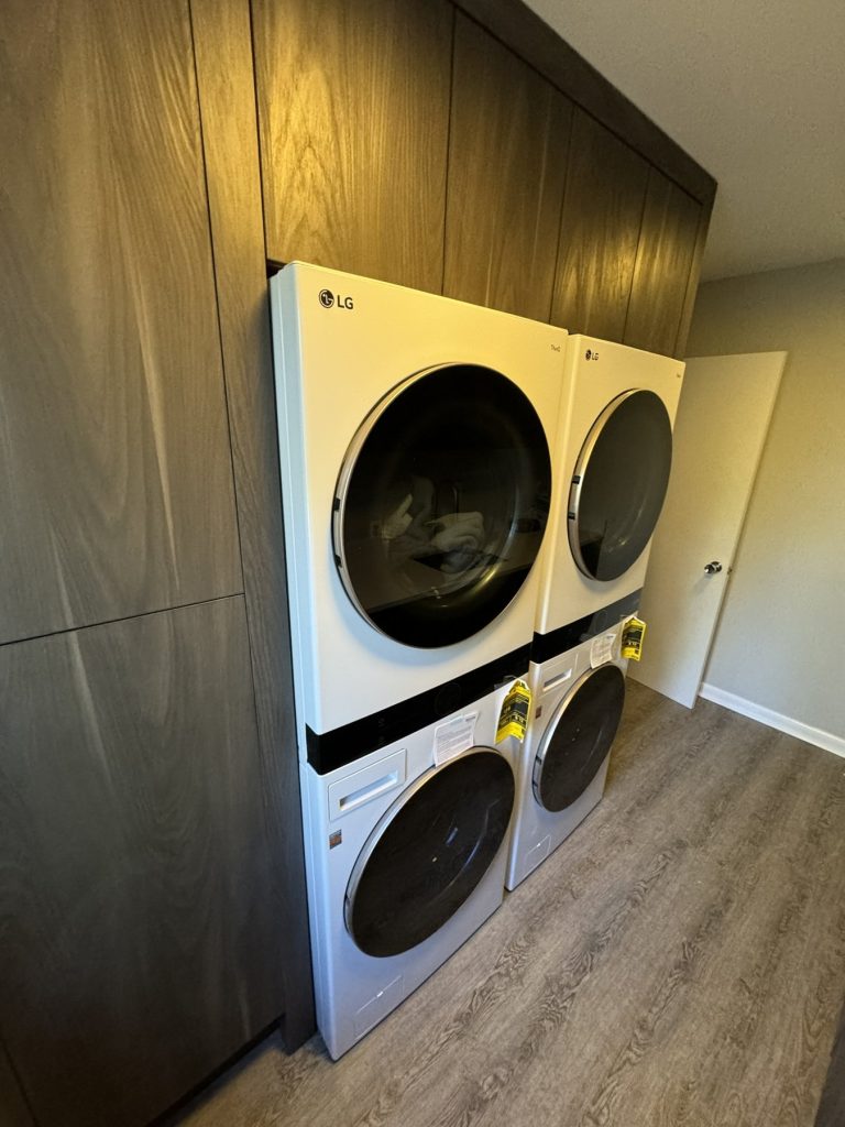 Custom laundry tower cabinetry with stacked washer and dryer
