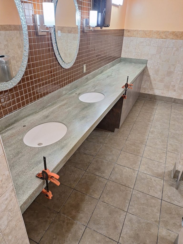 Cantilevered ADA vanity with dual sinks during installation by SMFW