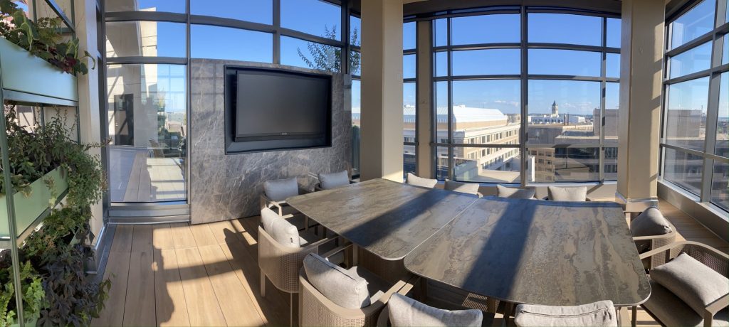 Rooftop dining terrace with stone media wall and outdoor TV, Washington DC