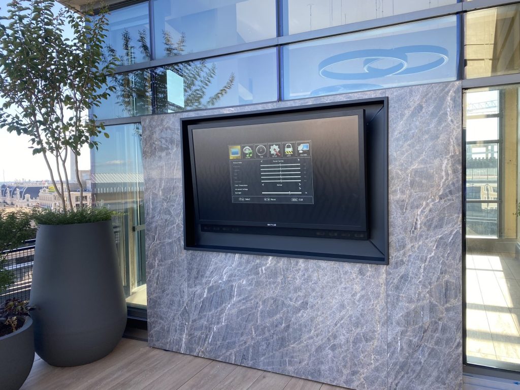 Outdoor TV recessed in custom stone surround, rooftop terrace