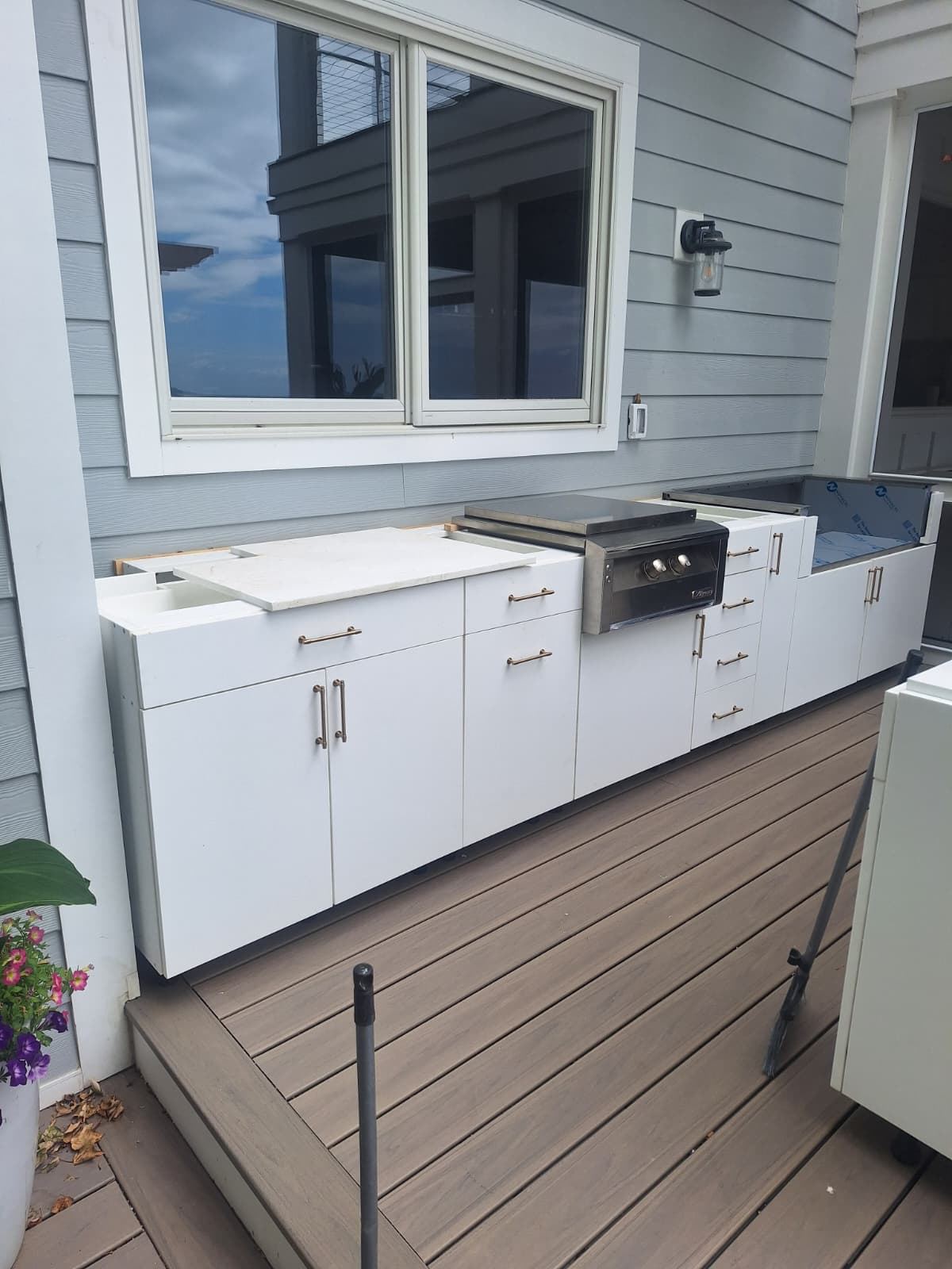 Outdoor cabinetry installation in progress on a composite deck