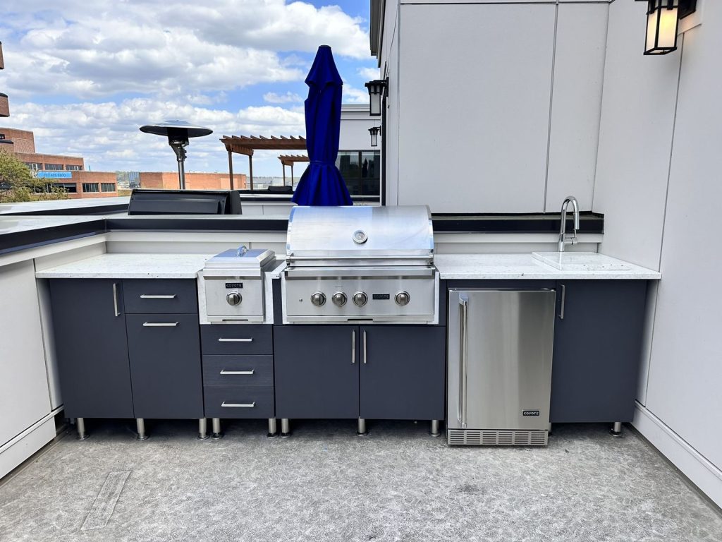 Rooftop outdoor kitchen with weather-rated cabinetry built by SMFW