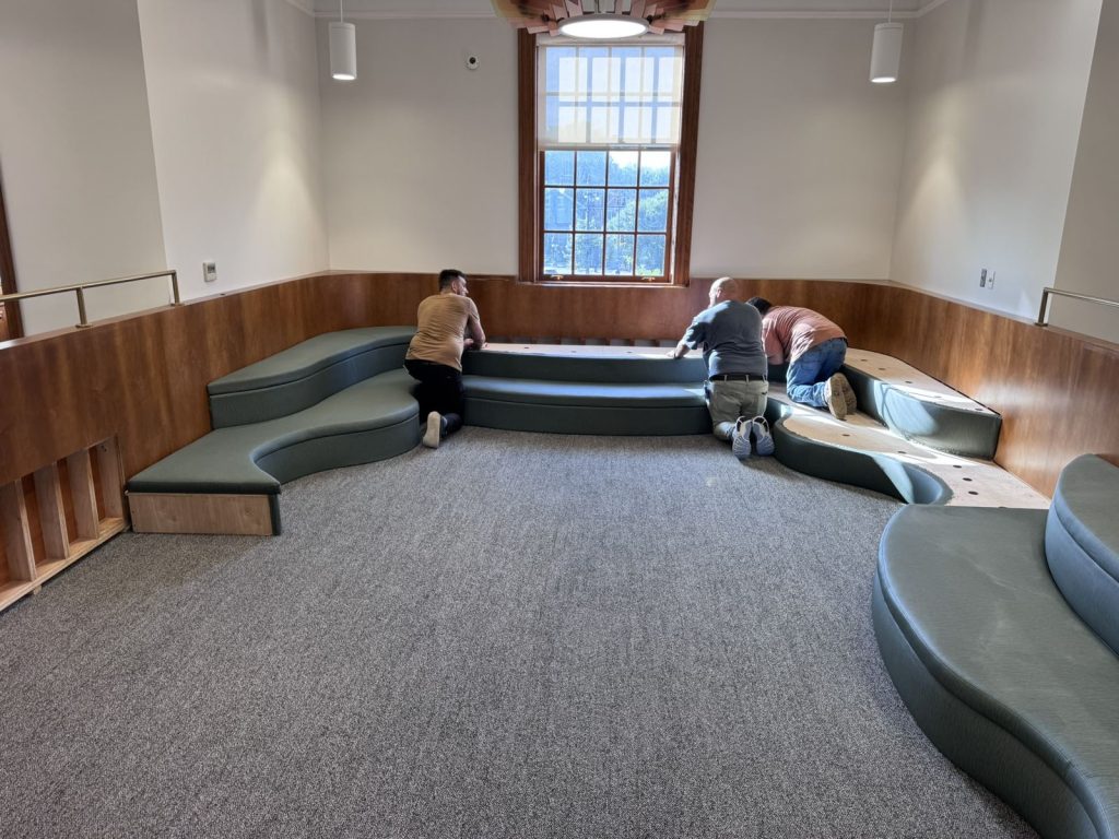SMFW install team placing upholstered cushions at the Petworth Neighborhood Library