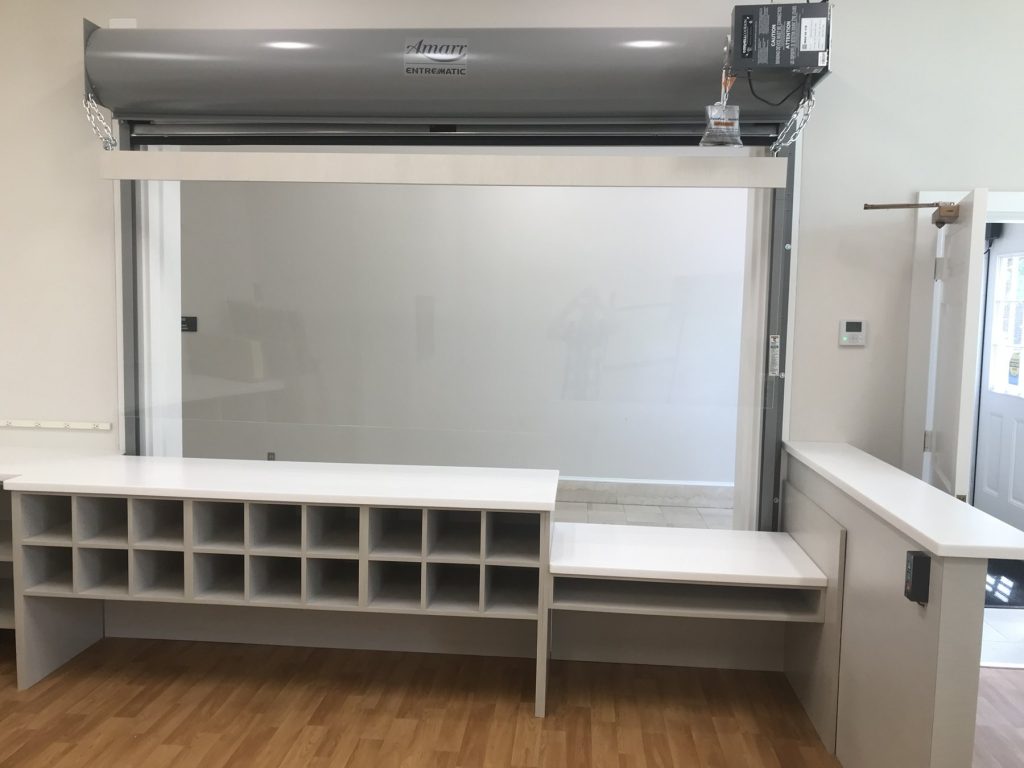Custom service counter with mail cubbies and roll-up service window at Washington College