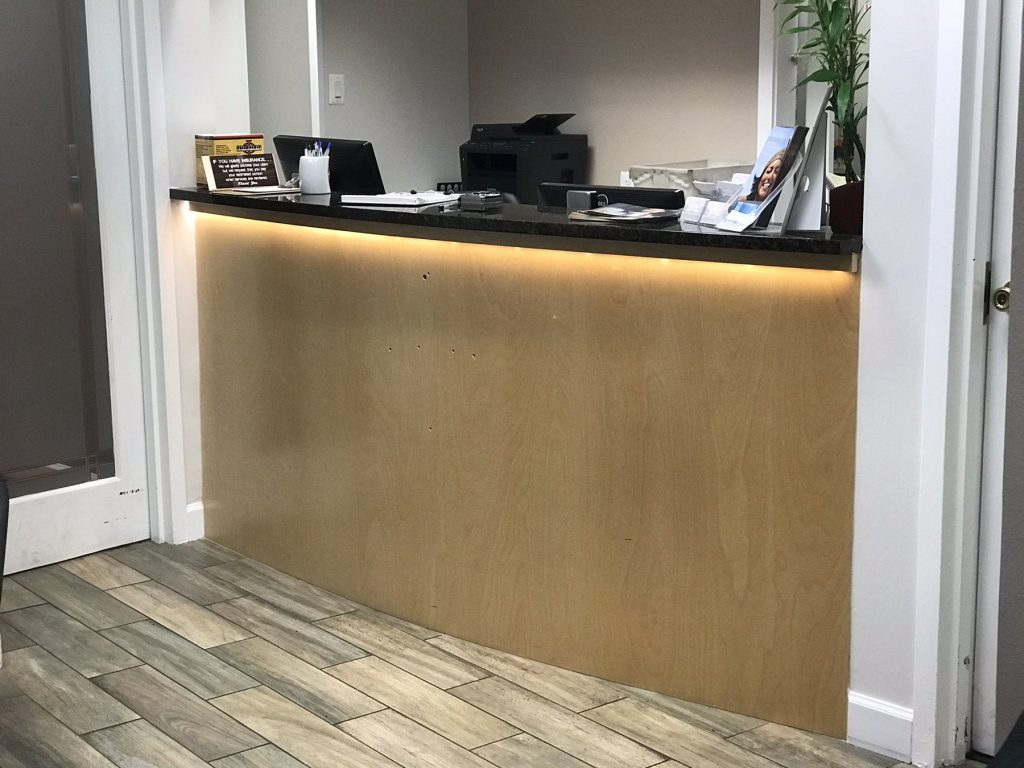 Reception desk with granite counter and under-counter accent lighting