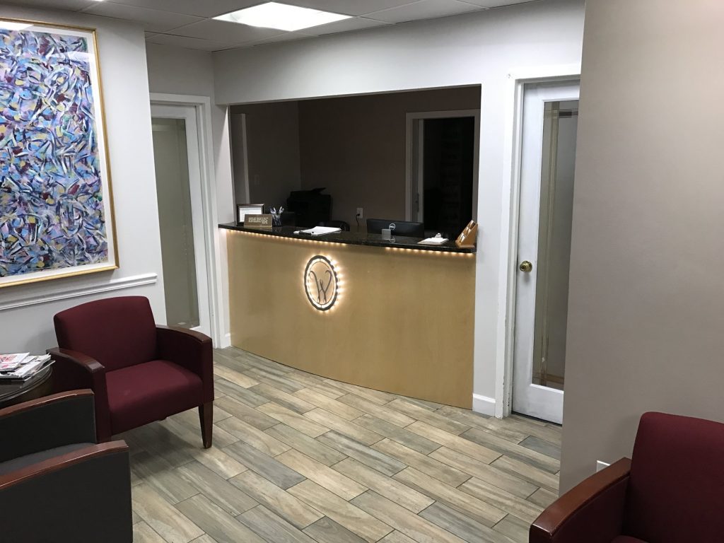 Dental office waiting room with custom curved reception desk by SMFW